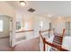 Bright hallway with white railings and a view from the second story landing at 6227 Castlecove Rd, Charlotte, NC 28278