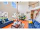 Bright living room featuring a fireplace, staircase, and large windows providing natural light at 6227 Castlecove Rd, Charlotte, NC 28278