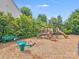 Community playground featuring swings, slides, and other fun play equipment for children to enjoy at 6227 Castlecove Rd, Charlotte, NC 28278