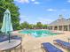 Community pool showcasing crystal-clear water, comfortable lounge seating, and a charming poolside clubhouse for residents at 6227 Castlecove Rd, Charlotte, NC 28278