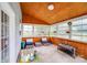 Cozy sunroom with wood-paneled ceiling and multiple windows offering natural light at 6227 Castlecove Rd, Charlotte, NC 28278