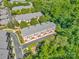 Aerial view showcases townhome community surrounded by mature trees and lush landscaping at 6312 Mission Pl, Charlotte, NC 28210