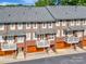 Exterior view of townhomes with charming balconies and attached garages at 6312 Mission Pl, Charlotte, NC 28210