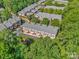Aerial view of a townhome community surrounded by lush green trees and manicured lawns at 6312 Mission Pl, Charlotte, NC 28210
