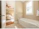 Inviting bathroom showcases a soaking tub and a glimpse into the well-appointed bedroom at 6312 Mission Pl, Charlotte, NC 28210