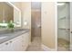 Elegant bathroom with double vanity, walk-in shower, and a spacious walk-in closet at 6312 Mission Pl, Charlotte, NC 28210