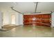 Clean garage featuring a stained wood garage door and access door to the outside at 6312 Mission Pl, Charlotte, NC 28210