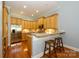 Bright kitchen with granite countertops, a breakfast bar, stainless steel appliances, and wood cabinets at 6312 Mission Pl, Charlotte, NC 28210