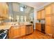 Open kitchen view with stainless steel appliances and a view to the living room's fireplace at 6312 Mission Pl, Charlotte, NC 28210