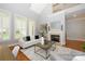 Bright living room with fireplace, hardwood floors, and many windows at 6312 Mission Pl, Charlotte, NC 28210