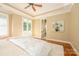 Sunlit main bedroom featuring hardwood floors, neutral tones, and access to a private balcony at 6312 Mission Pl, Charlotte, NC 28210