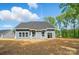 The backyard features a blue home with large windows, a well-manicured lawn, and plenty of space for outdoor activities at 910 Westminster Dr, Statesville, NC 28677