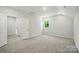 This bedroom offers neutral carpet, a window, and an ensuite bathroom at 910 Westminster Dr, Statesville, NC 28677