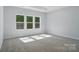 Spacious bedroom features carpet floors and large windows allowing for natural light at 910 Westminster Dr, Statesville, NC 28677