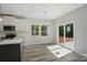 Bright dining area features chandelier, sliding glass door, and large windows overlooking the yard at 910 Westminster Dr, Statesville, NC 28677