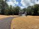 Charming two-story home with a paved driveway and lush greenery providing a private setting at 910 Westminster Dr, Statesville, NC 28677