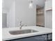 Close-up of the kitchen island, featuring a stainless steel sink and white countertop at 910 Westminster Dr, Statesville, NC 28677