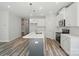 Bright kitchen features an island with white countertop, stainless appliances, and white cabinets at 910 Westminster Dr, Statesville, NC 28677