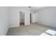 Main bedroom with carpet, tray ceiling, and views into the main bathroom at 910 Westminster Dr, Statesville, NC 28677