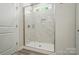 Modern bathroom features a spacious walk-in shower with marble tile and glass door at 910 Westminster Dr, Statesville, NC 28677