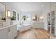 Bright bathroom featuring a freestanding tub, double vanities, large windows, and modern fixtures at 922 Everett Pl, Charlotte, NC 28205