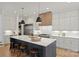 Bright kitchen with stainless steel appliances, an island with barstool seating, and modern pendant lighting at 922 Everett Pl, Charlotte, NC 28205