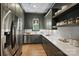 Stylish kitchen with modern stainless steel appliances, hardwood floors, and open shelving storage space at 922 Everett Pl, Charlotte, NC 28205