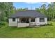 Back exterior view with covered patio and well-maintained yard at 9564 Regent Dr, Davidson, NC 28036
