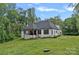Well-maintained lawn and landscaping, complemented by a covered patio for outdoor enjoyment at 9564 Regent Dr, Davidson, NC 28036