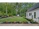 Well-manicured backyard featuring green grass, landscaping, and a storage shed, next to the home at 9564 Regent Dr, Davidson, NC 28036
