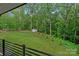 Spacious backyard with lush lawn, mature trees, and a storage shed visible from the deck at 9564 Regent Dr, Davidson, NC 28036