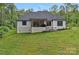 Exterior of home showing back patio, landscaping, and sprawling lawn at 9564 Regent Dr, Davidson, NC 28036