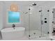 Stunning bathroom showcasing soaking tub, glass enclosed shower, and modern finishes at 9564 Regent Dr, Davidson, NC 28036