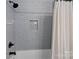 Well-lit bathroom with shower-tub combo and tiled wall with practical shower niche at 9564 Regent Dr, Davidson, NC 28036