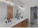 Modern bathroom with double vanity, quartz countertop, and a tiled shower at 9564 Regent Dr, Davidson, NC 28036