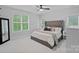 Bright bedroom with large windows, neutral décor, and a comfortable upholstered bed at 9564 Regent Dr, Davidson, NC 28036