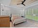 Bright bedroom with wood-paneled ceiling, neutral decor, and large windows overlooking the yard at 9564 Regent Dr, Davidson, NC 28036