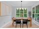 Bright dining room with a wooden table, modern lighting, and large windows with scenic views at 9564 Regent Dr, Davidson, NC 28036
