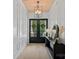 Elegant foyer featuring paneled walls, hardwood floors, and a modern chandelier at 9564 Regent Dr, Davidson, NC 28036