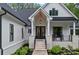 Inviting entryway with double doors, stone accents, and a covered porch at 9564 Regent Dr, Davidson, NC 28036