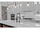 Modern kitchen features white cabinetry, quartz countertops, and stainless steel appliances at 9564 Regent Dr, Davidson, NC 28036