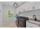 Functional laundry room with modern washer and dryer, and ample cabinet storage at 9564 Regent Dr, Davidson, NC 28036