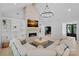 Bright living room with a stone fireplace, built-in bookshelves, and modern chandelier at 9564 Regent Dr, Davidson, NC 28036