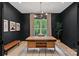 Stylish home office with dark walls, a large wooden desk, and ample natural light at 9564 Regent Dr, Davidson, NC 28036