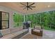 Relaxing outdoor patio with comfortable seating and a view of the lush, wooded backyard at 9564 Regent Dr, Davidson, NC 28036
