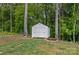 Backyard storage shed on a well-maintained lawn surrounded by mature trees at 9564 Regent Dr, Davidson, NC 28036