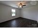 This bedroom has dark wood-look floors, a ceiling fan, and a window to let in natural light at Tbd Alf Hoover Rd # 4, Lincolnton, NC 28092
