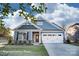 Charming single-Gathering home with blue siding, stone accents, a two-car garage, and manicured lawn at 106 S Inneswood Ln # 31, Mooresville, NC 28115