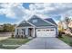 Charming single-Gathering home with blue siding, stone accents, a two-car garage, and manicured lawn at 106 S Inneswood Ln # 31, Mooresville, NC 28115