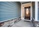 Close-up of an elegant, dark wood front door with glass insert and decorative trim at 106 S Inneswood Ln # 31, Mooresville, NC 28115